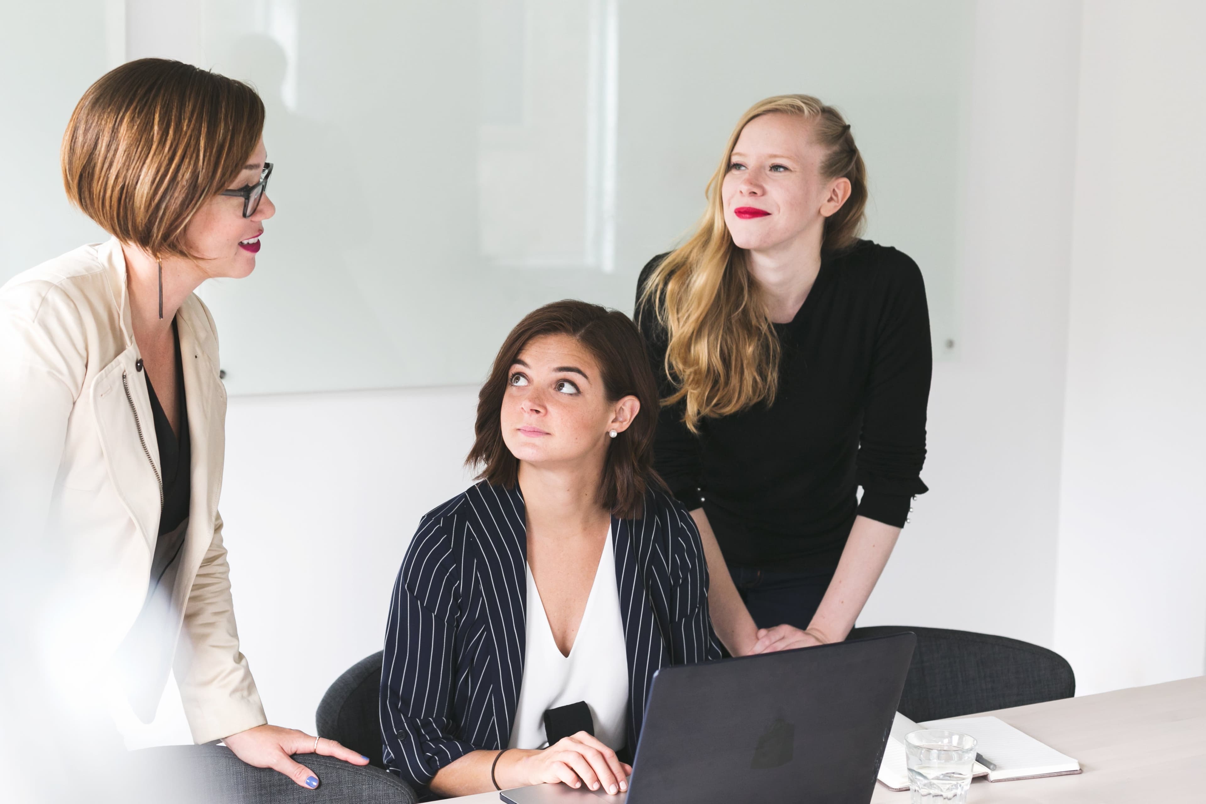 Three colleagues reviewing a cohort deployment plan